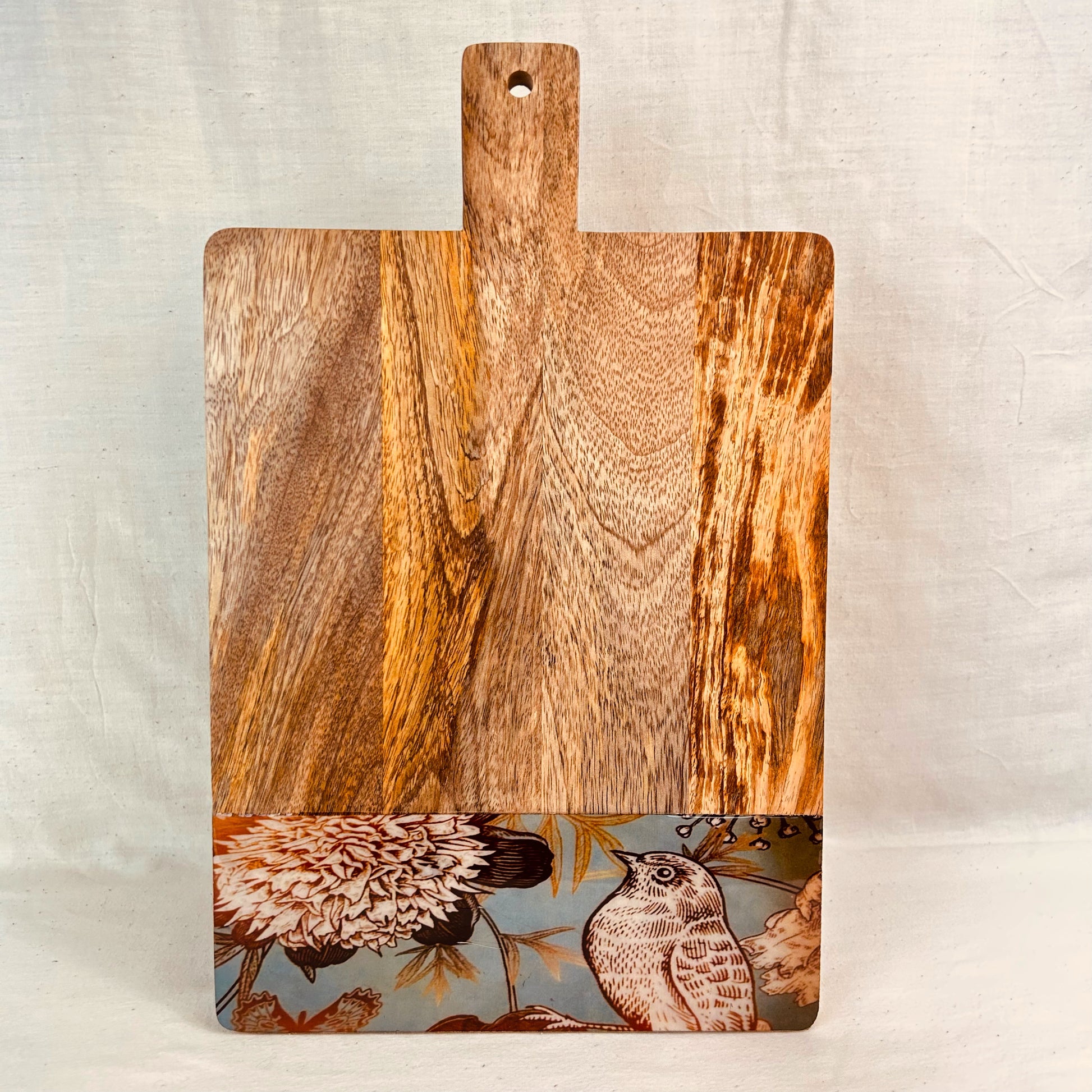 Mango Wood Cheese Board with handle. The Charcuterie Board has a nature, bird and flowers print at the bottom of the board.