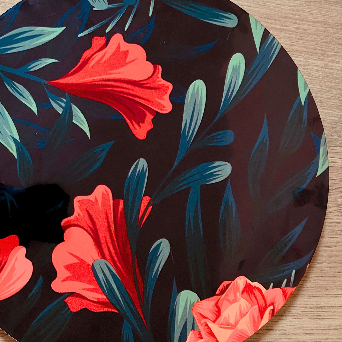 Close Up of a Floral printed Decorative Tray or Placemat placed on a wooden backdrop.