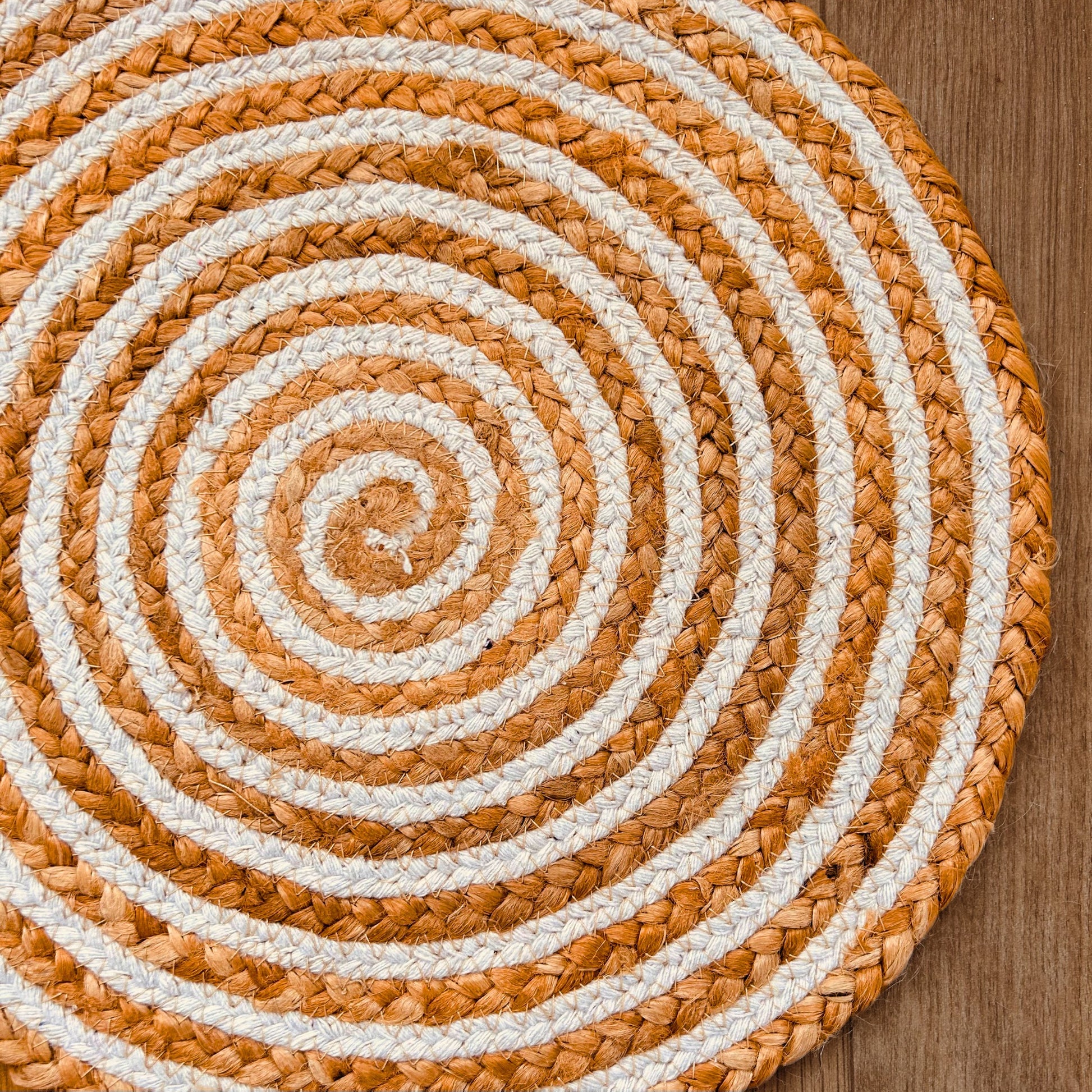 Close Up 100% Natural Round Jute and Cotton Braided Placemat in brown and white stripes.