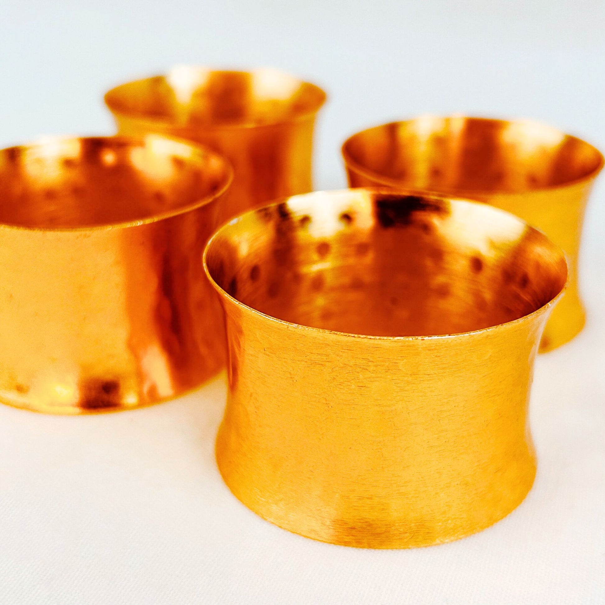 A set of 4 Gold Hammered Finish Napkin Rings.