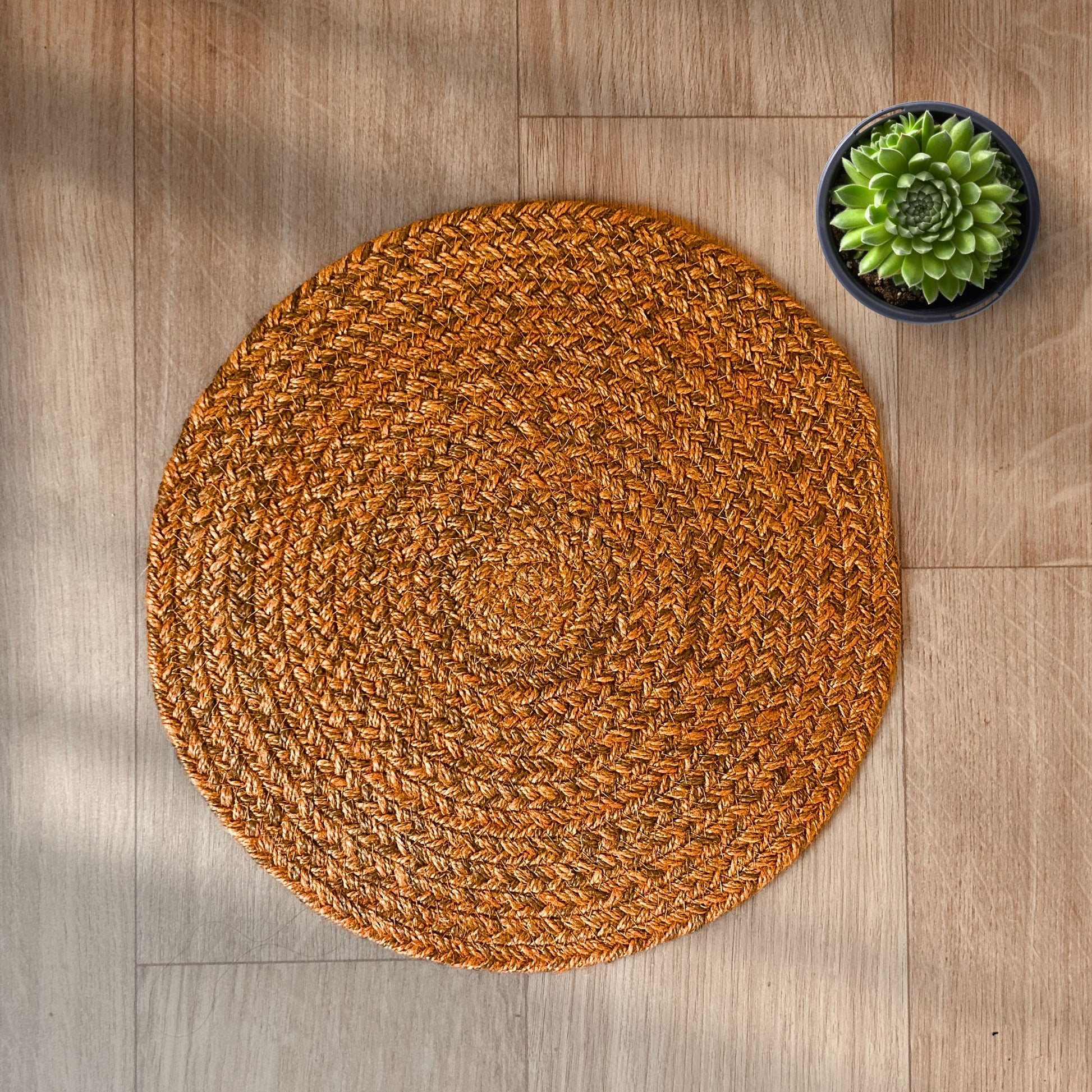 100% Jute placemats placed on a wooden backdrop with a succulent on the side