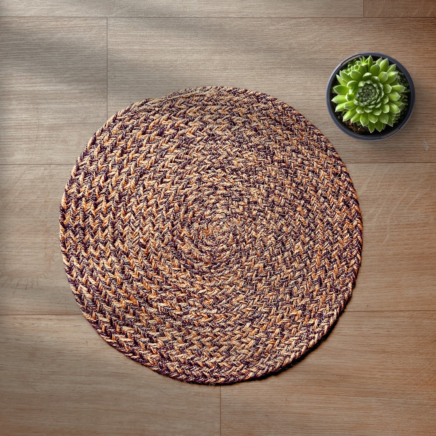 100% Jute placemats placed on a wooden backdrop with a succulent on the side