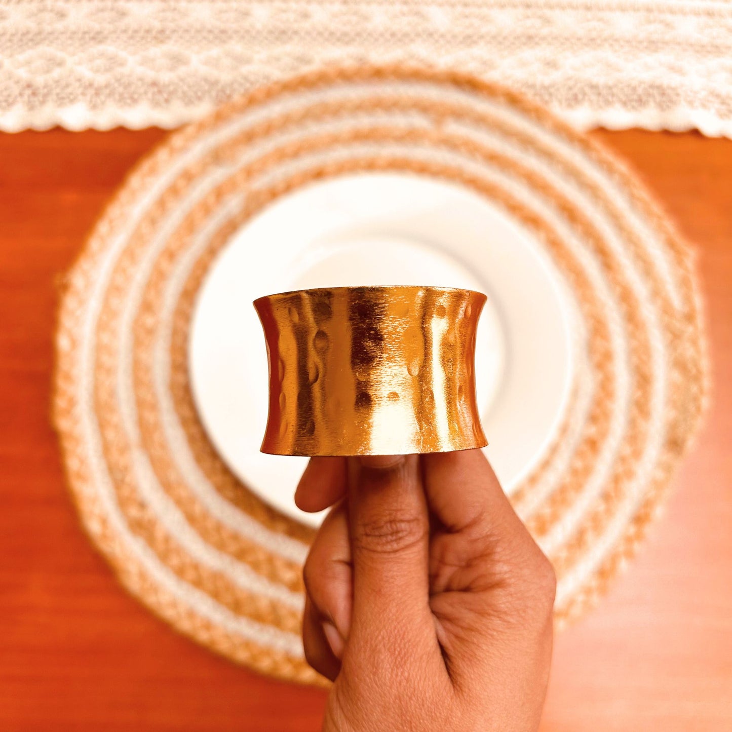 Model holding a Gold Hammered Finish Napkin Ring.