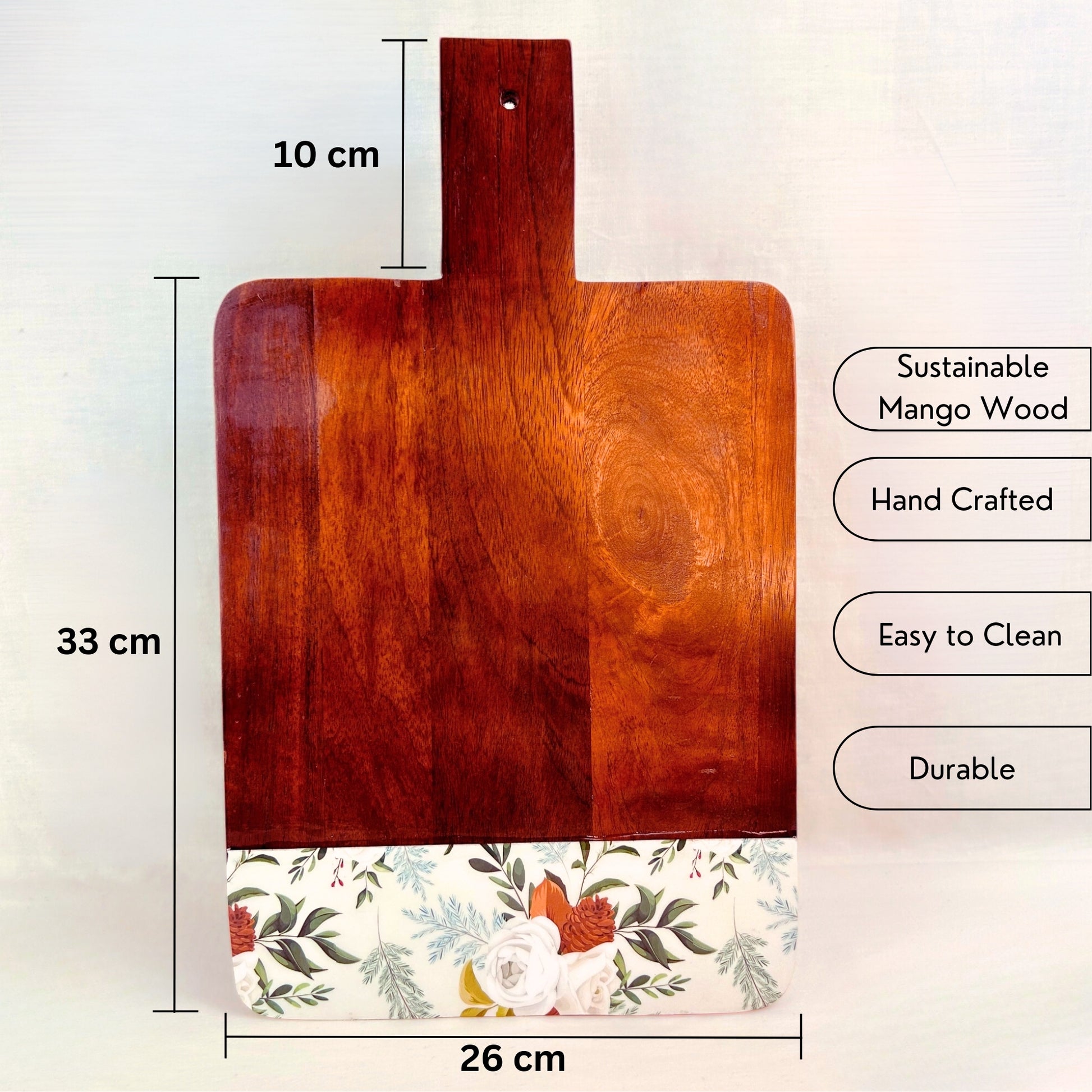 Mango Wood Cheese or Charcuterie Board with print of white roses, pinecones and leaves on the bottom as a border. It has dimensions and USP of the cheese board mentioned.