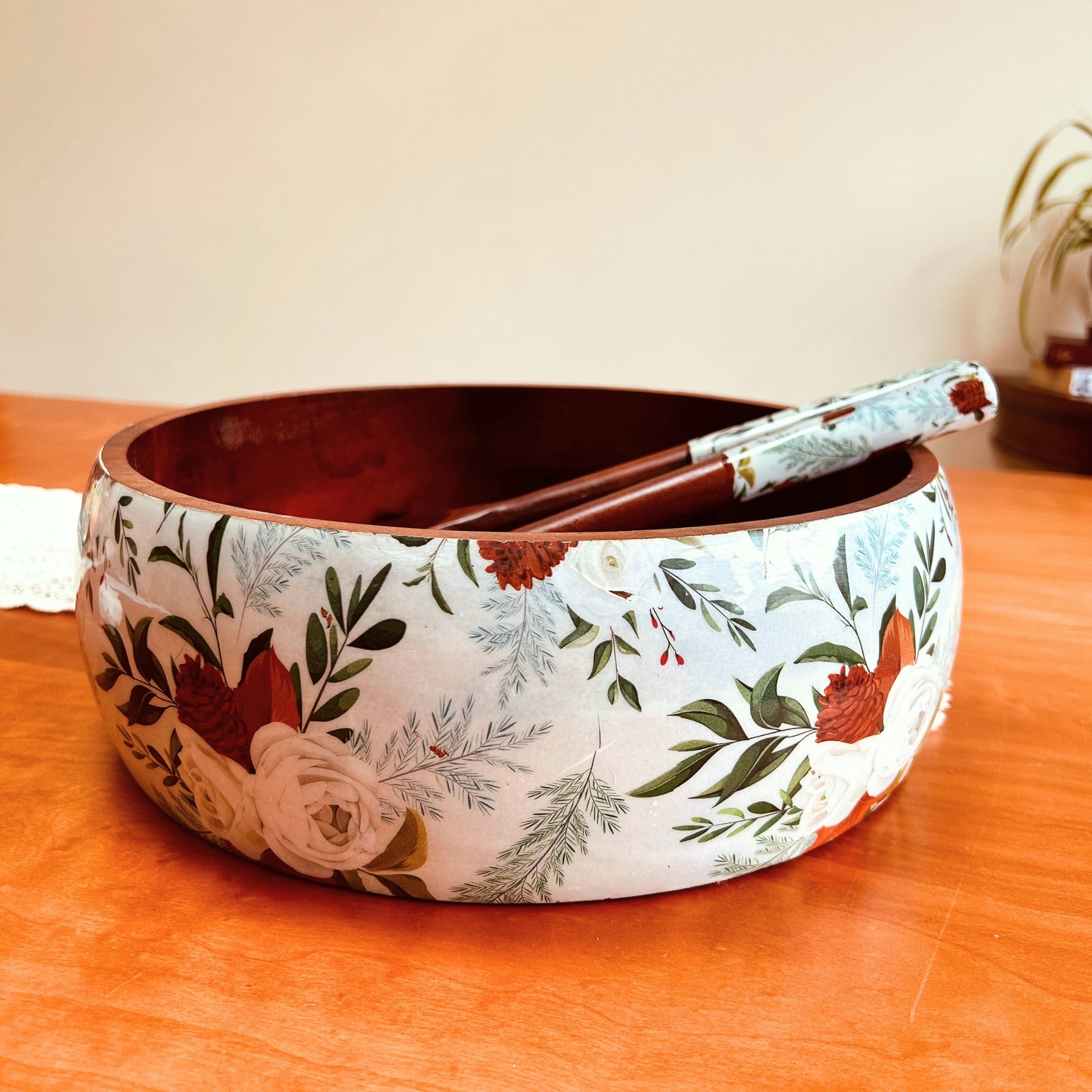 A large mango wood salad bowl with english roses print. It also has wooden salad servers with print on the handle.