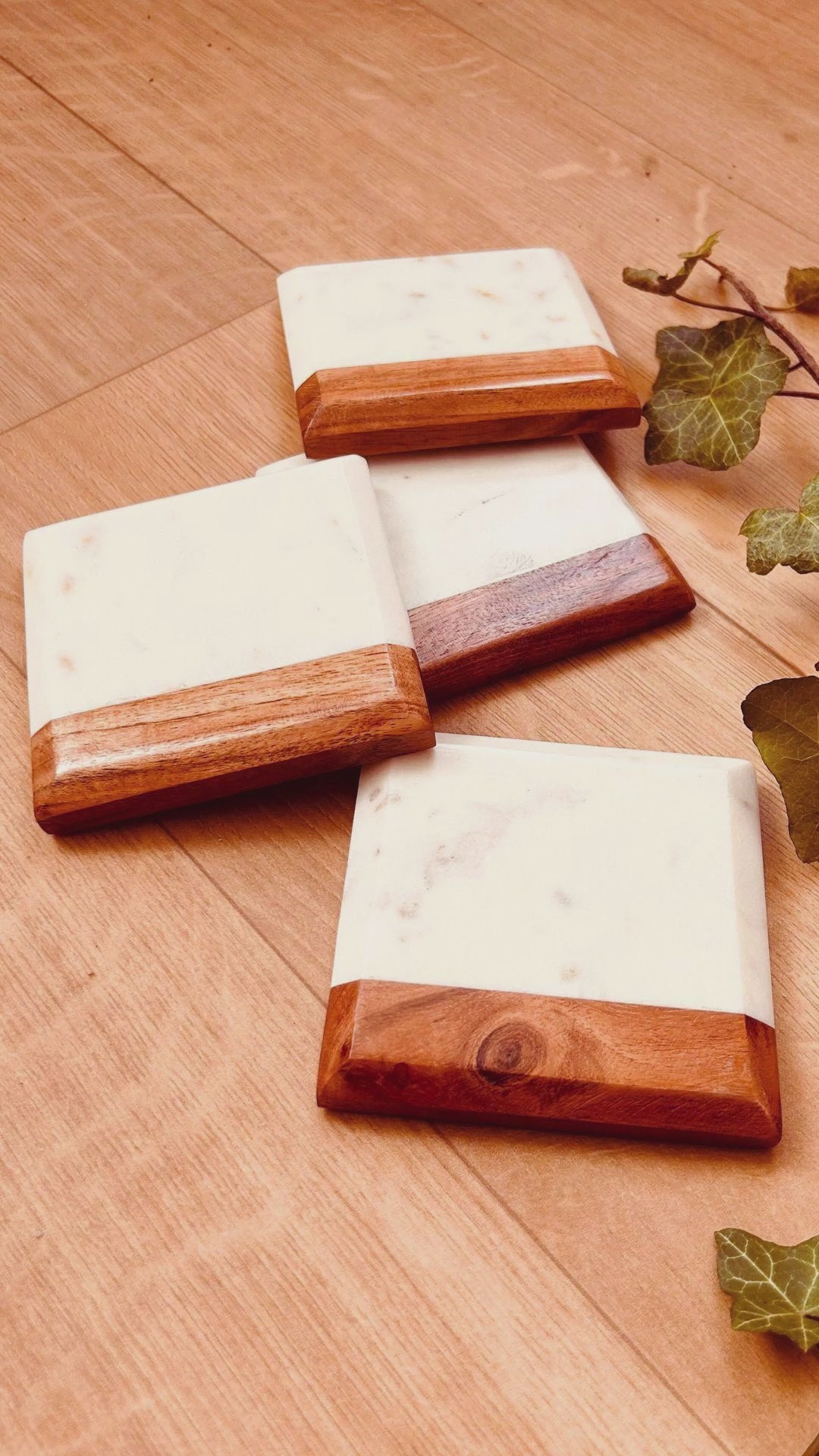 A video showcasing the size, dimensions and scale of acacia wood and white marble square drink coasters.