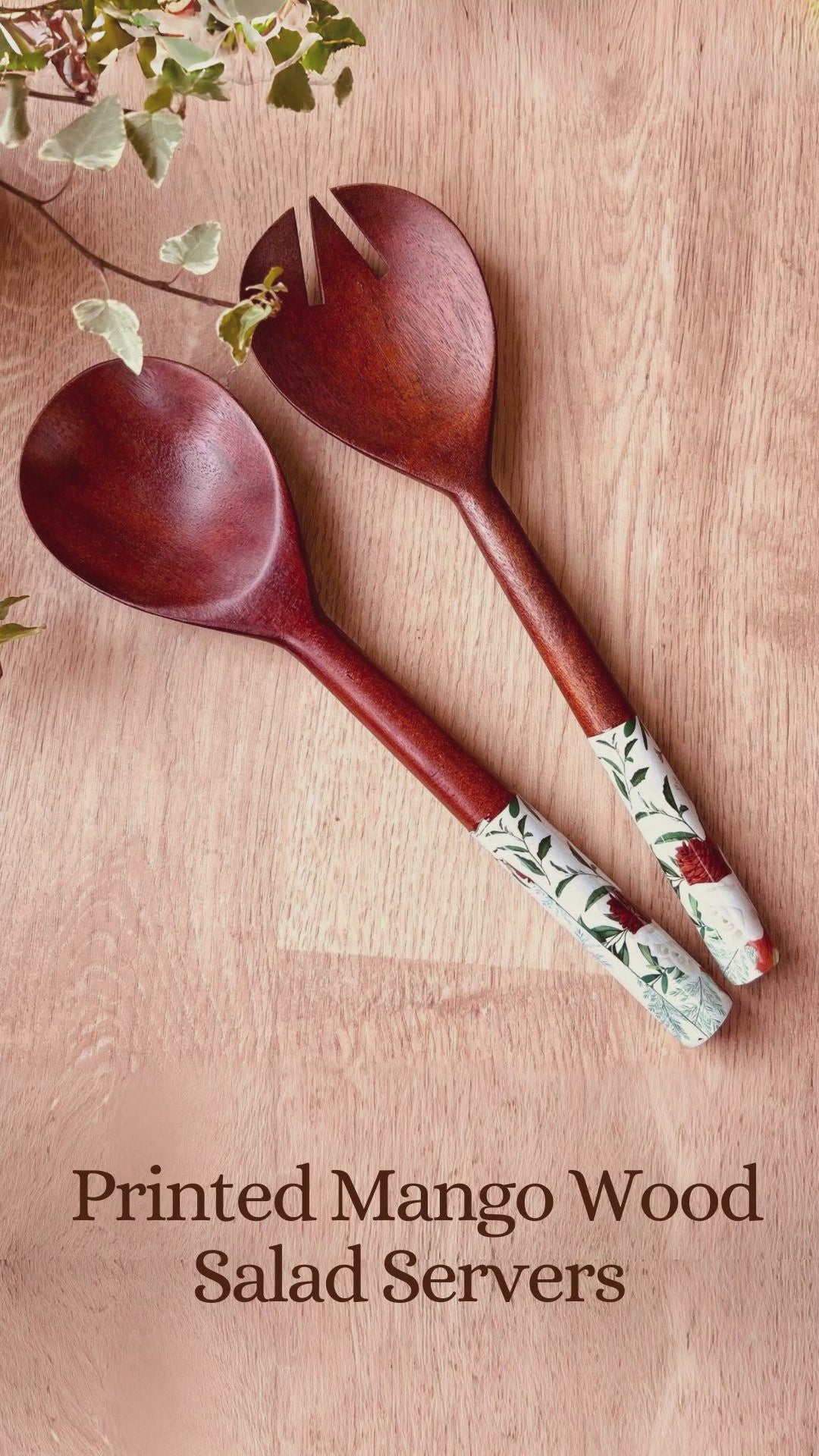 A product video showcasing a pair of mango wood salad servers with nature print on the handle ends.